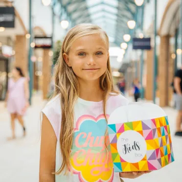 Girl holding kids box